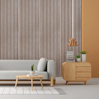 Salotto moderno con divano grigio, tavolino in legno, lampada e piante su un mobile.