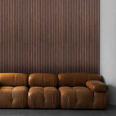 Brown leather sofa against a wooden slatted wall.