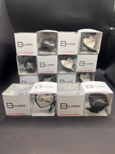 Set of boxed heart-shaped decorative items stacked neatly on a dark surface.